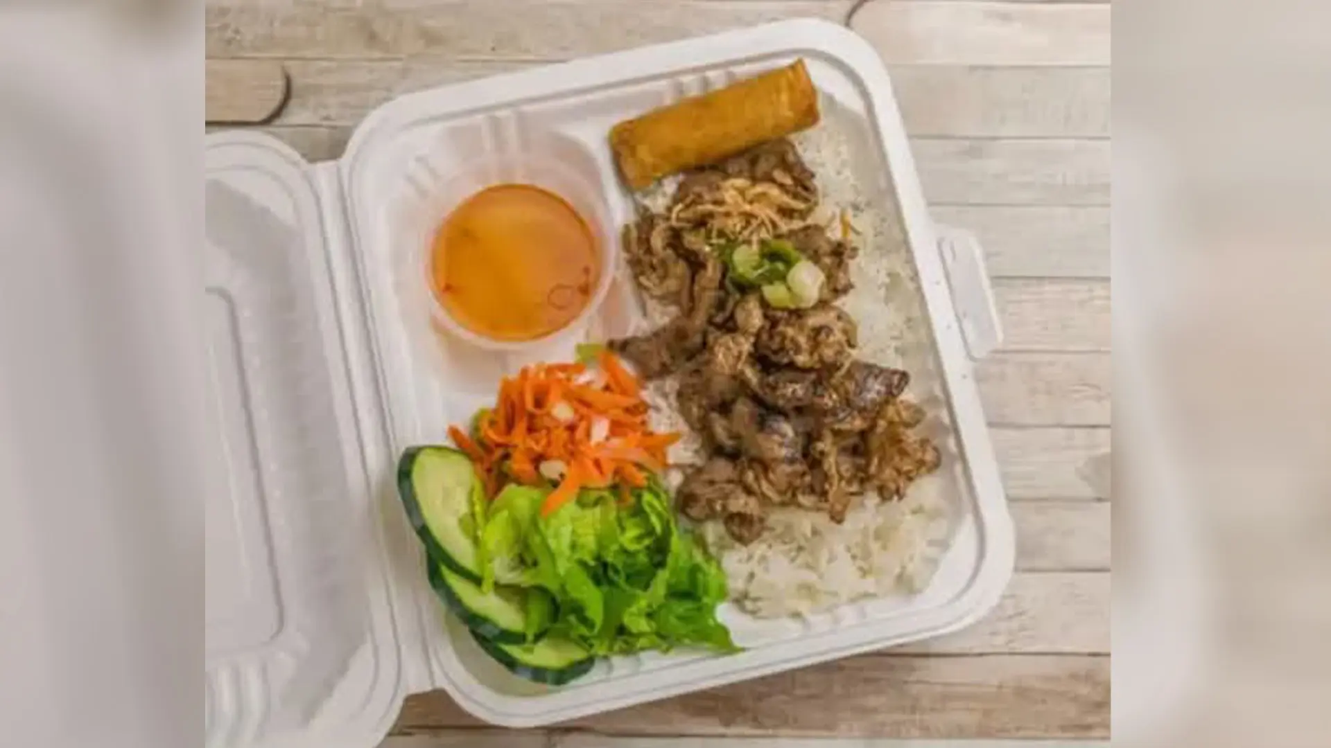 BBQ chicken with rice, veggies, egg roll at Big Boss Banh Mi, a Vietnamese Restaurant in Houston