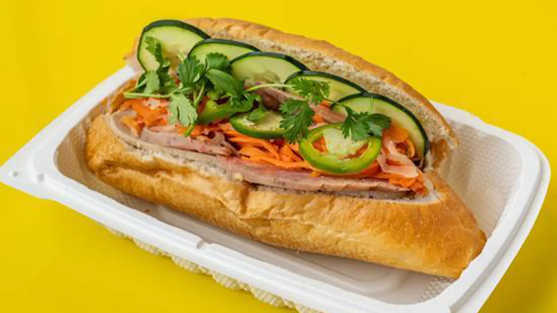 Banh mi with veggies, meat, cilantro at Big Boss Banh Mi, a Vietnamese Restaurant in Houston